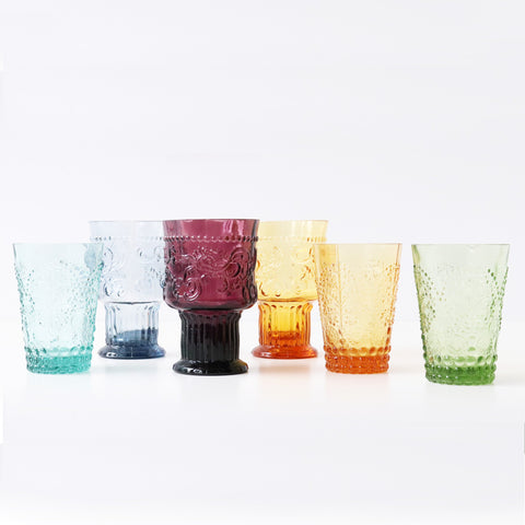 Jewel coloured drinking glasses with ornate relief patterns