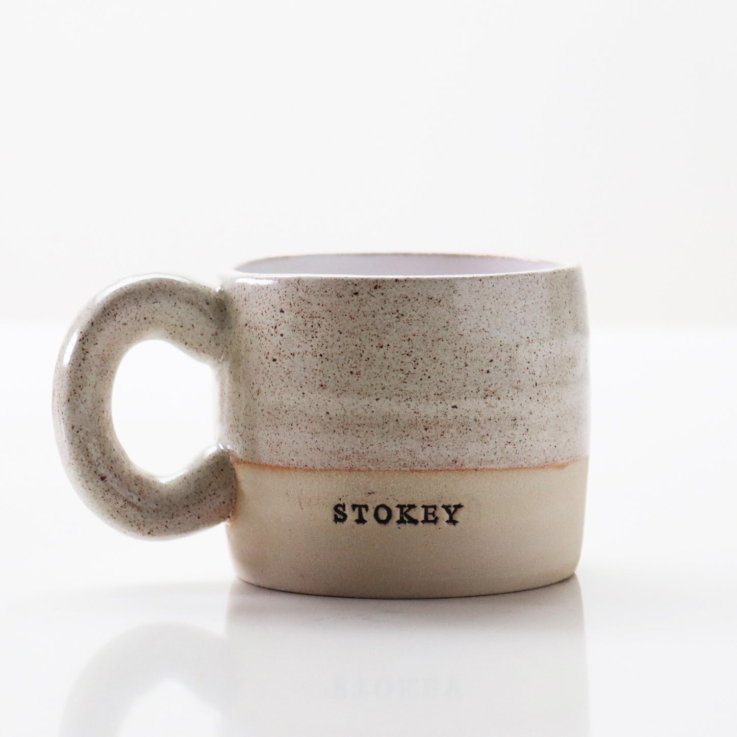 Grey speckled mug stamped ‘Stokey’ by Lesley McShea