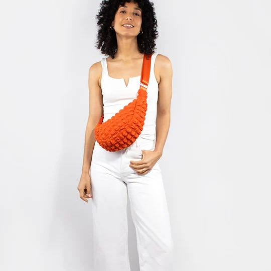 Kind Bag crossbody bag in bright orange waffle texture – sunny, energetic design made from recycled plastic