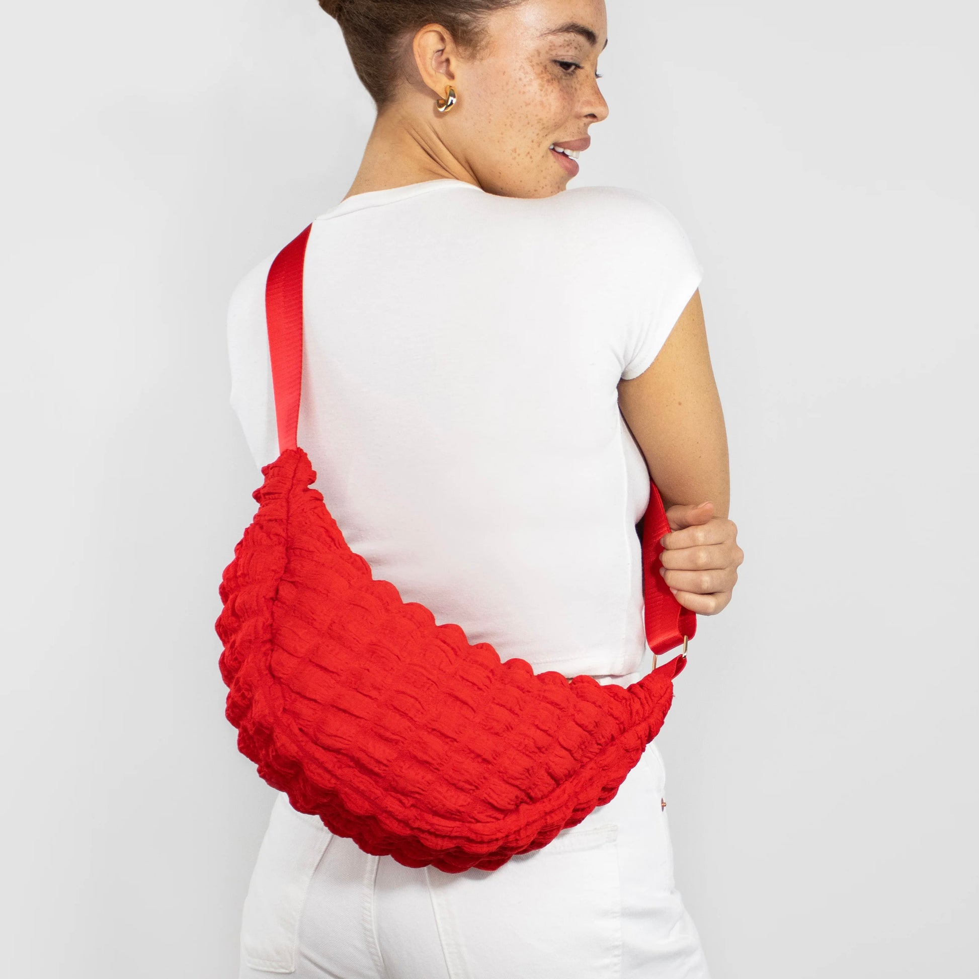 Kind Bag crossbody bag in red waffle texture – playful and vibrant design made from recycled materials