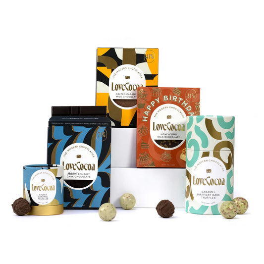 A collection of Love Cocoa chocolate products, including bars and truffles, packaged in various colorful and patterned wrappers.