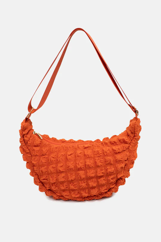 Kind Bag crossbody bag in bright orange waffle texture – sunny, energetic design made from recycled plastic