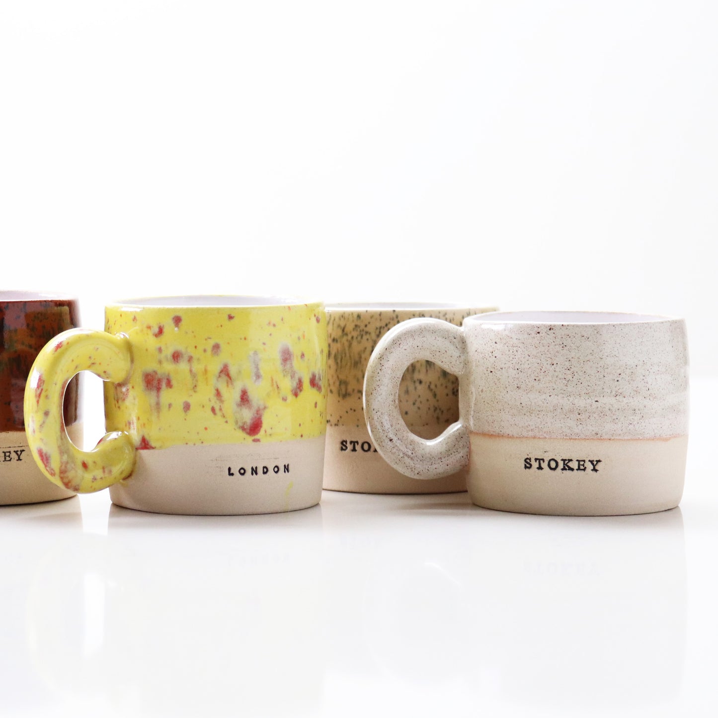 Handmade ceramic mug by Lesley McShea in in various colourways, stamped with ‘London’ or 'Stokey' – crafted in Stoke Newington